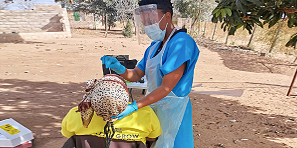 Nurse Thandy Nyalungu with a participant in the PHIRST study in Agincourt